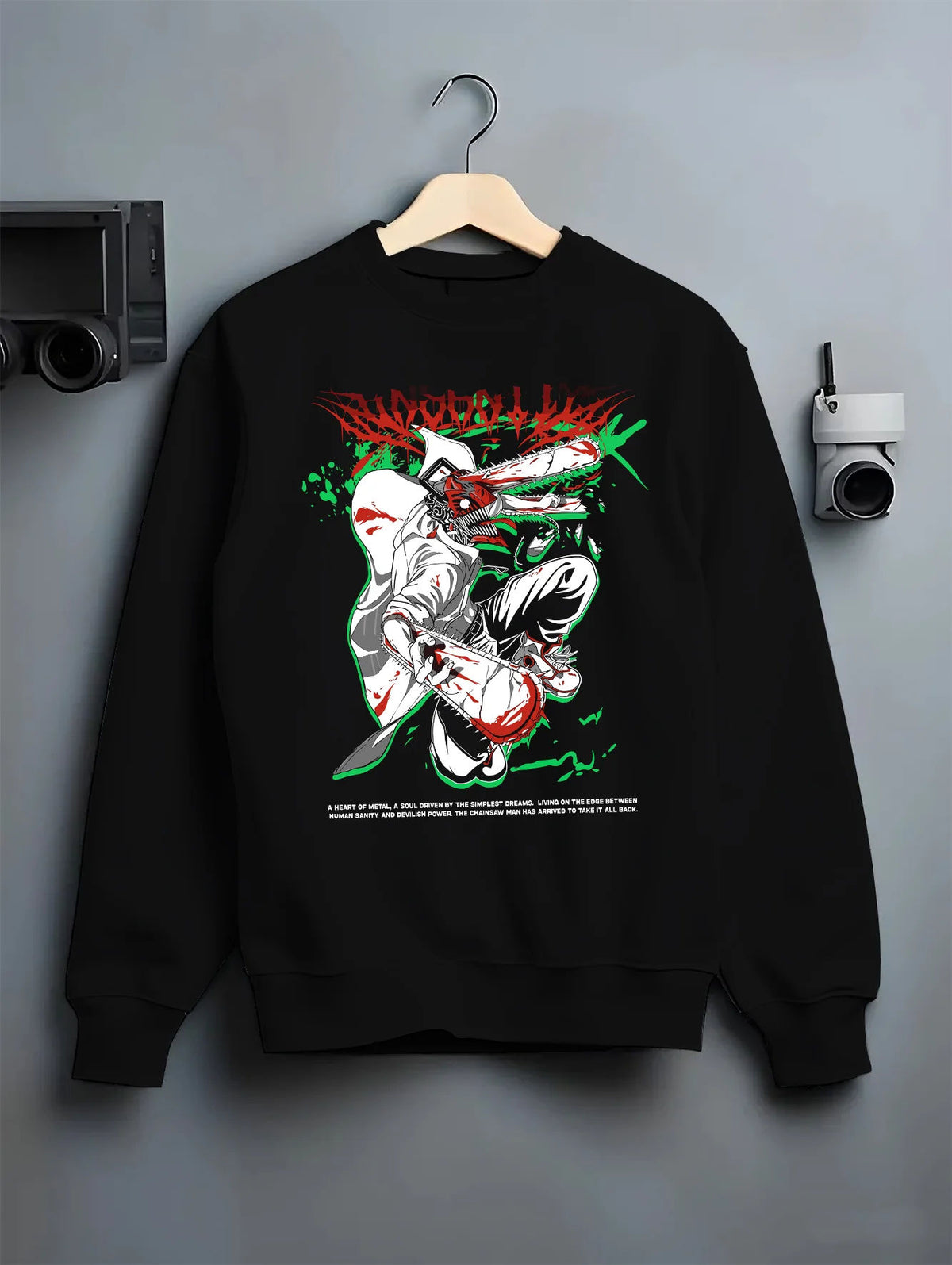 Black crewneck sweatshirt on hanger showing Chainsaw Devil / Denji from Chainsaw Man: white, green and red chainsaw suit