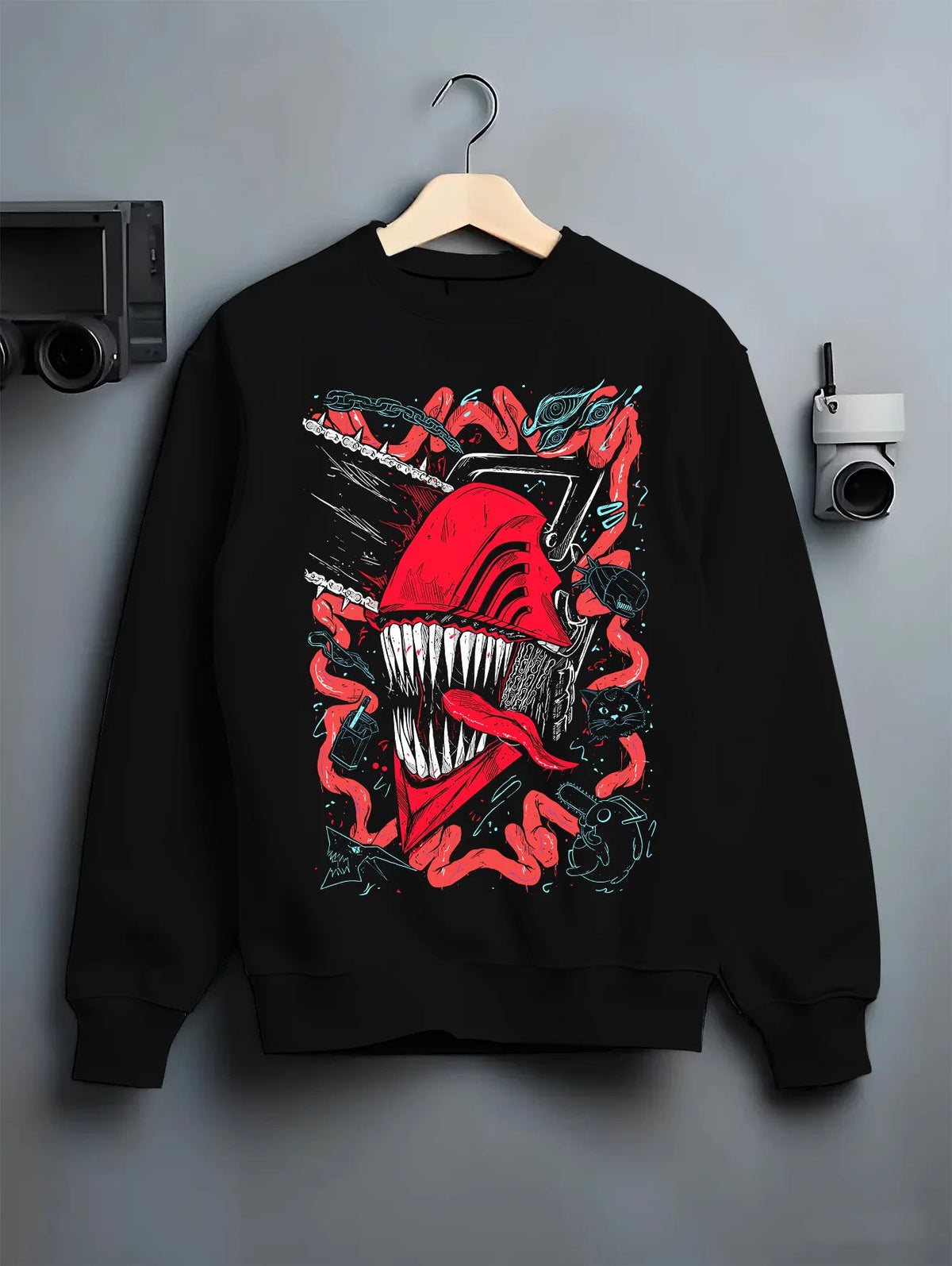 Black crewneck sweatshirt on hanger showing Chainsaw Devil / Denji from Chainsaw Man: pink-red toothed chainsaw head