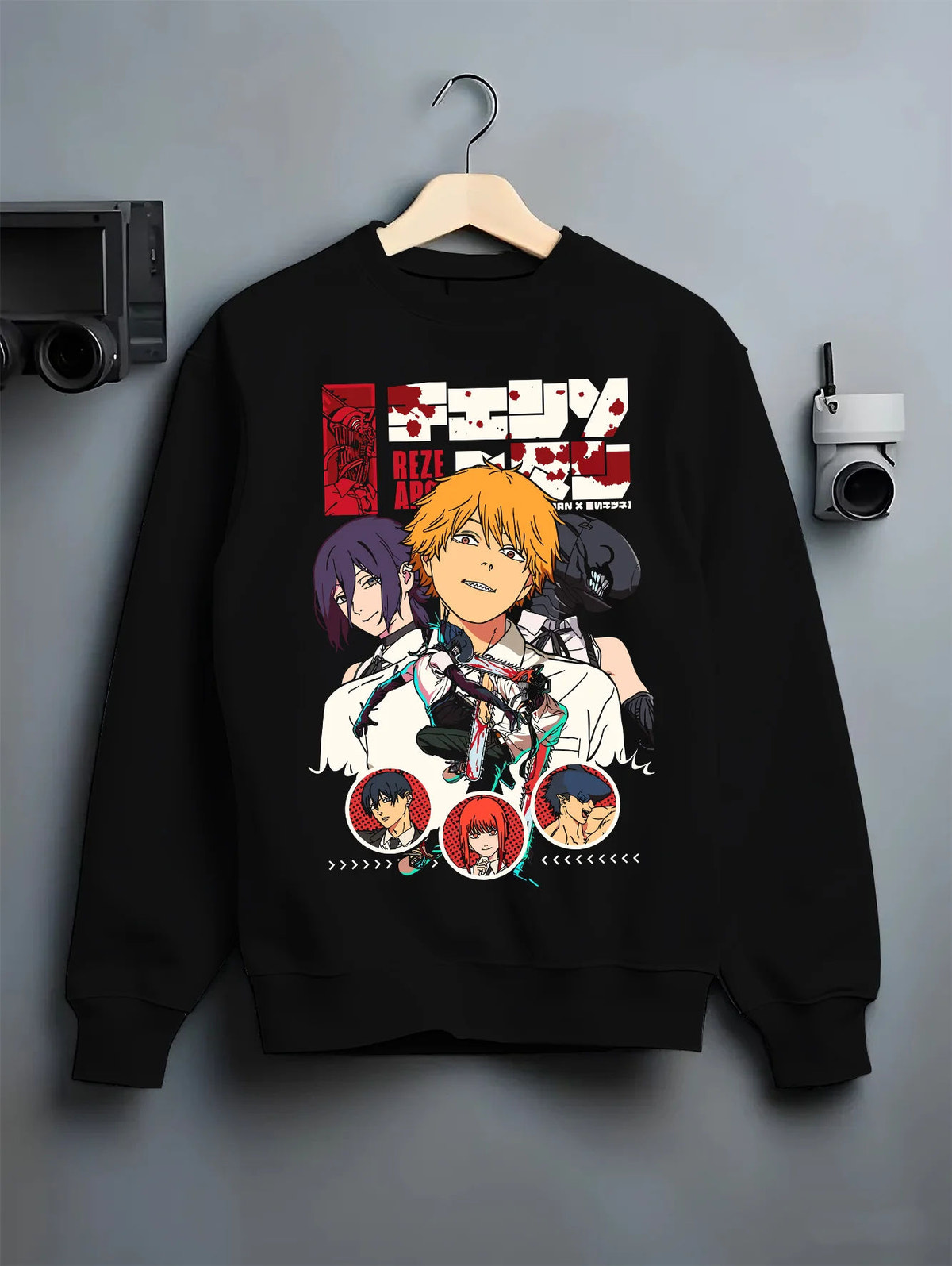 Black crewneck sweatshirt on hanger with Chainsaw Man ensemble including Denji, Makima and Aki illustrated back graphic