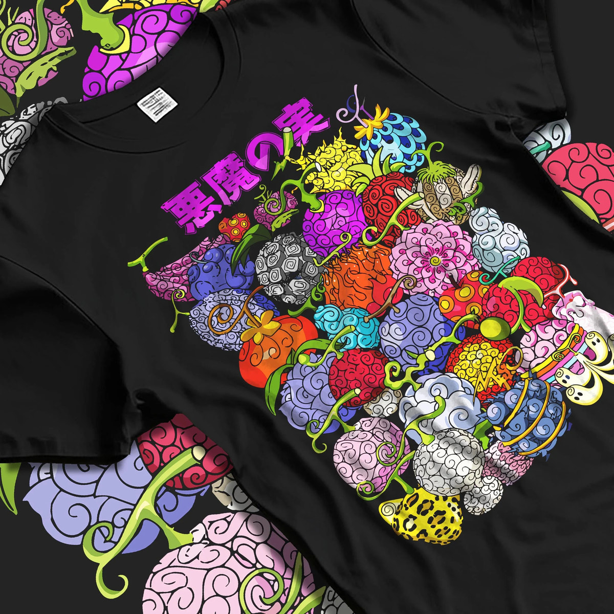 Black T-shirt laid flat with natural folds featuring One Piece devil fruit collage artwork.