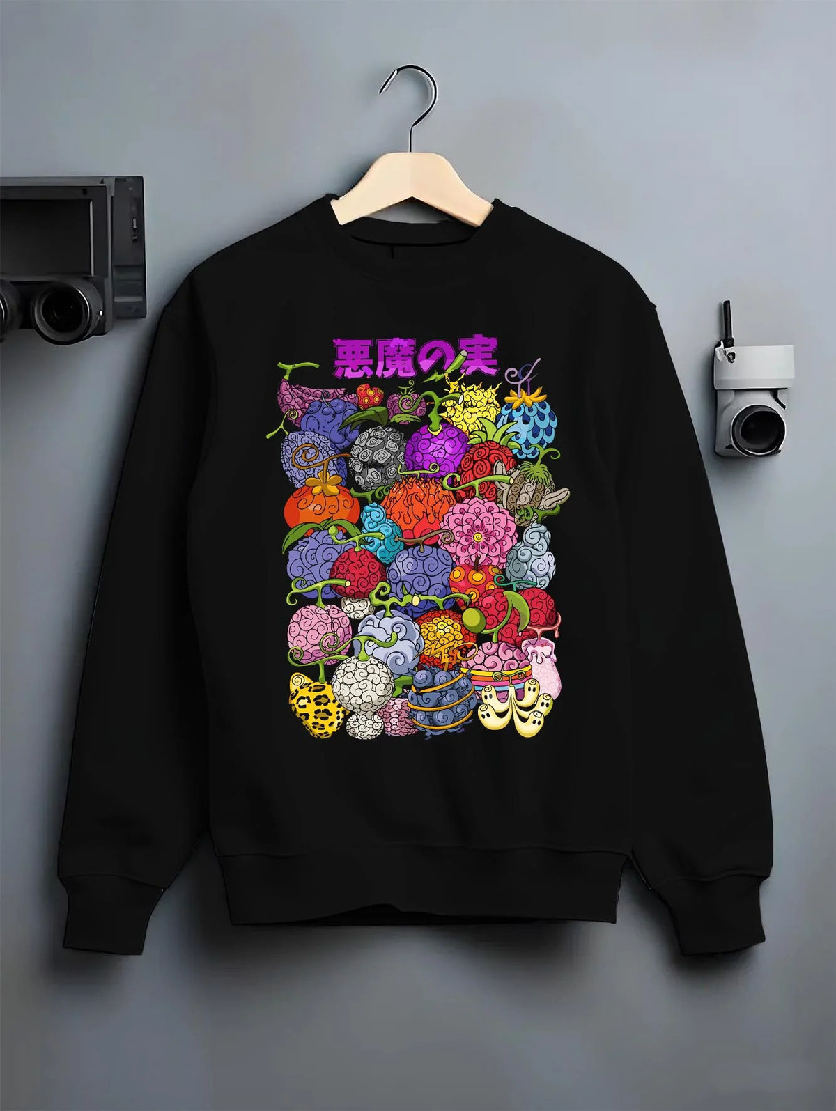 Black crewneck sweatshirt on hanger featuring One Piece devil fruit collage artwork.