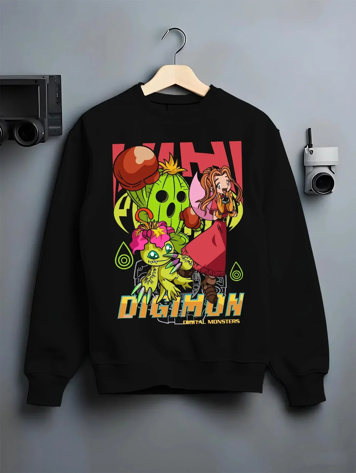Black crewneck sweatshirt on hanger with Digimon Hoodie Mimi with Palmon Retro Partner Print graphic premium wear.