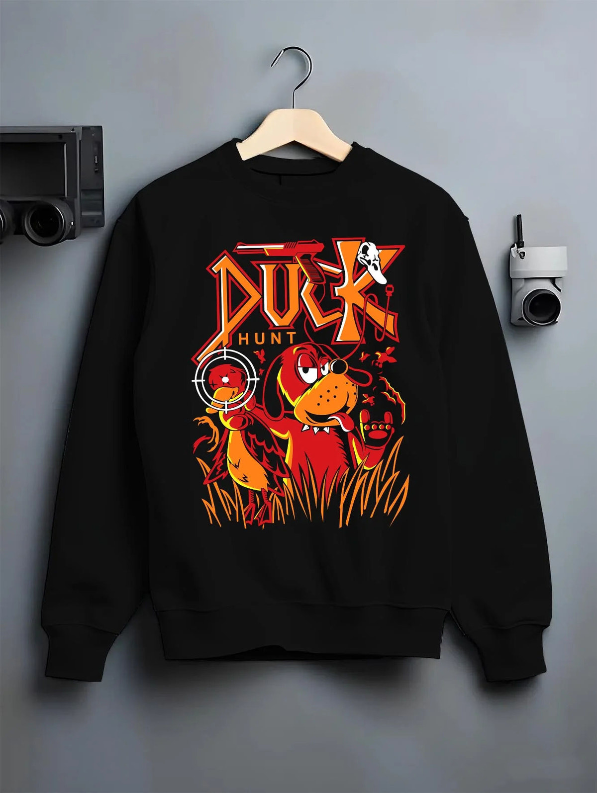 Black crewneck sweatshirt on hanger featuring Duck Hunt retro gaming dog artwork.