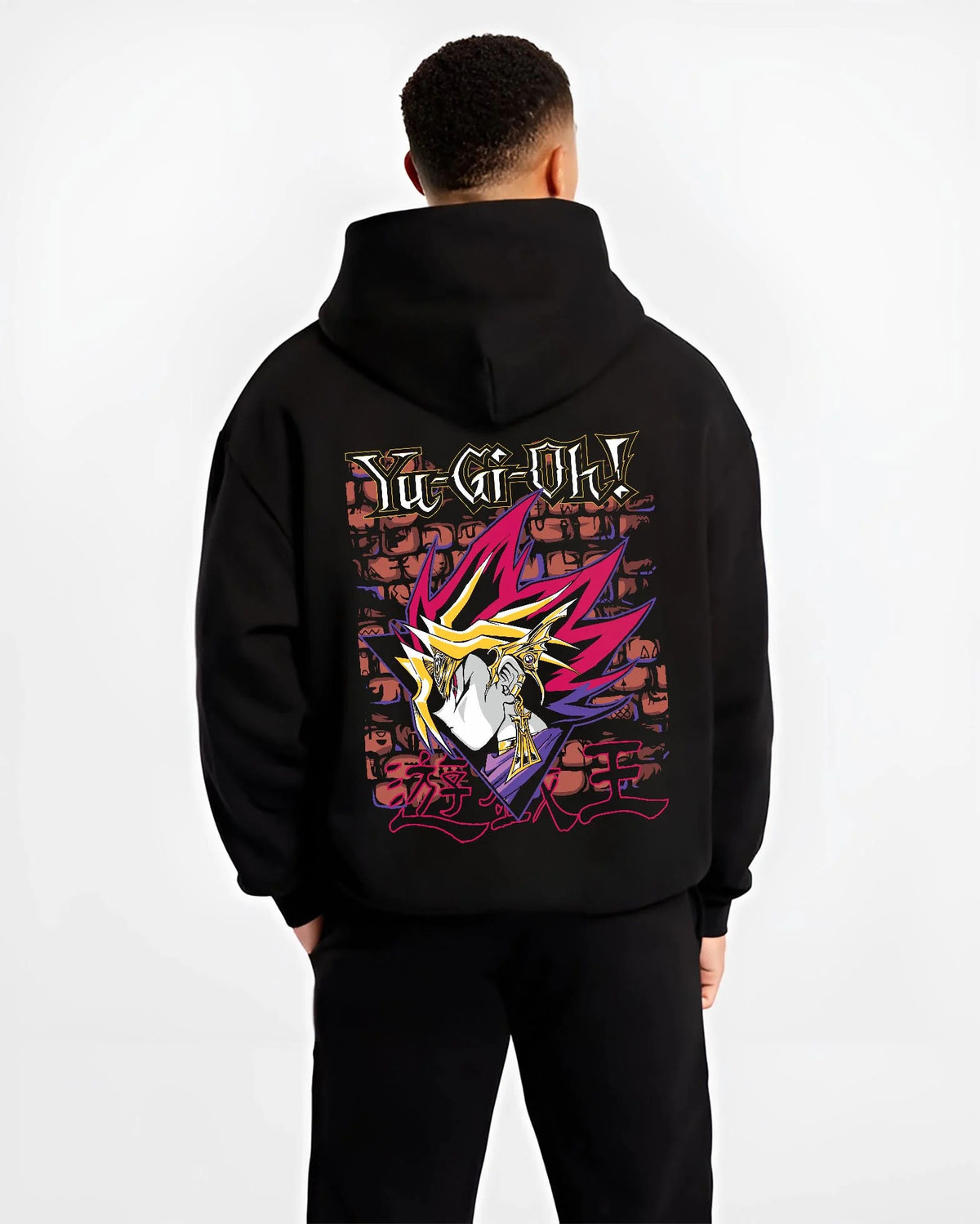 Black hoodie worn by male model from the back featuring Dark Magician Yu-Gi-Oh duel monster artwork.