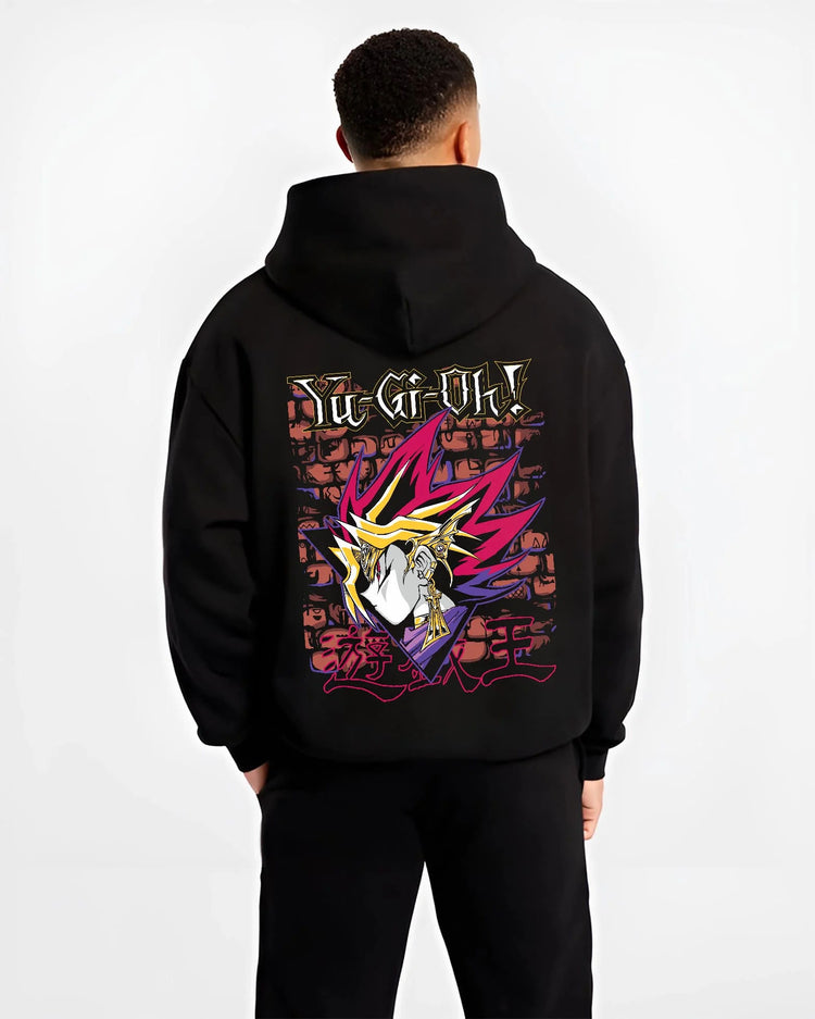 Black hoodie worn by male model from the back featuring Dark Magician Yu-Gi-Oh duel monster artwork.