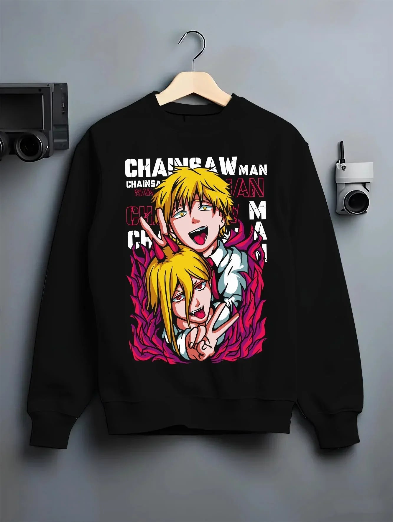 Black crewneck sweatshirt on hanger with Chainsaw Man Hoodie Denji Power Anime Retro Poster graphic streetwear graphic.