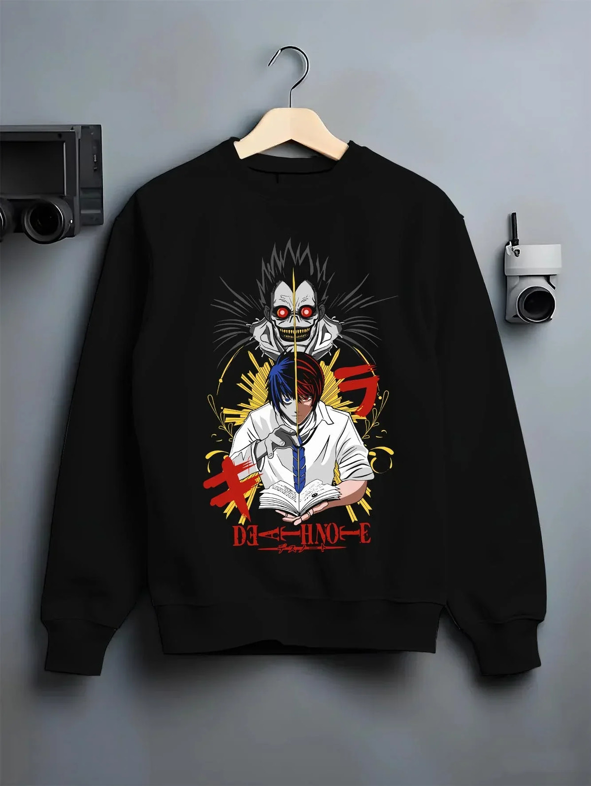 Black crewneck sweatshirt on hanger with Ryuk Hoodie Death Note Retro Anime Shinigami Poster graphic bold anime graphic.