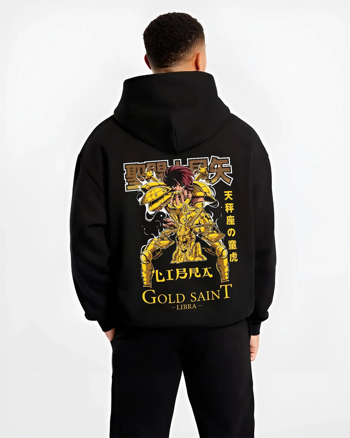 Black hoodie worn by male model, back view with Libra Hoodie Saint Seiya Gold Saint Armour Retro graphic bold anime graphic.