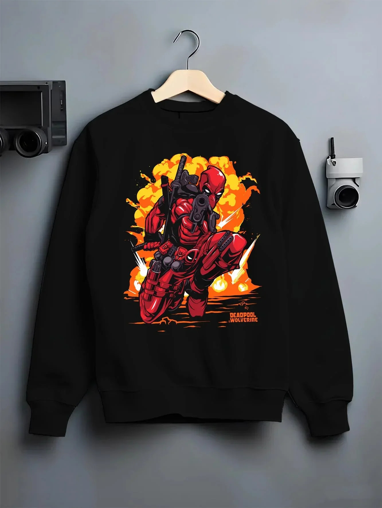 Black crewneck sweatshirt on hanger with Deadpool Hoodie Marvel Anime Cross Retro Parody Art graphic streetwear graphic.