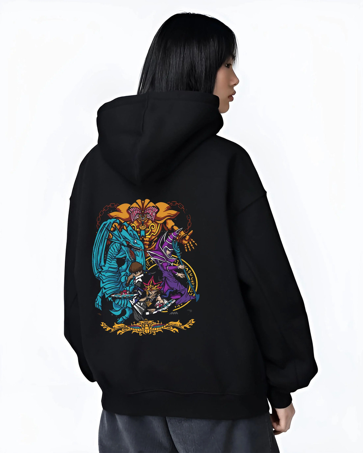 Black hoodie worn by female model from the back featuring Yu-Gi-Oh Egyptian Gods trio artwork.