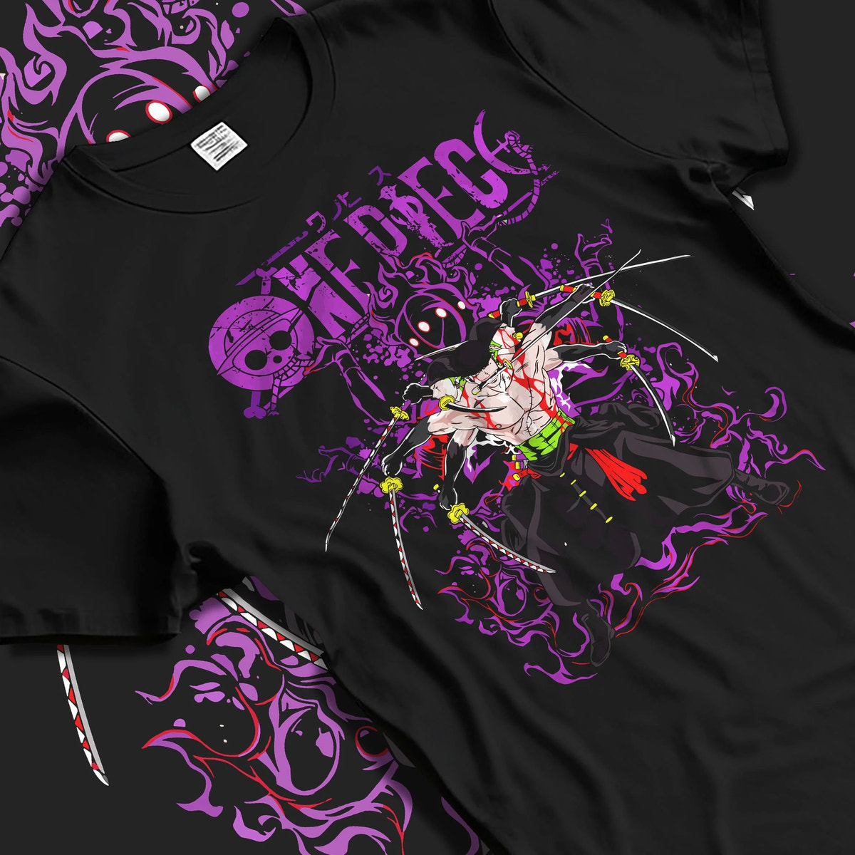 Black T-shirt laid flat with natural folds featuring Roronoa Zoro One Piece Enma King of Hell artwork.