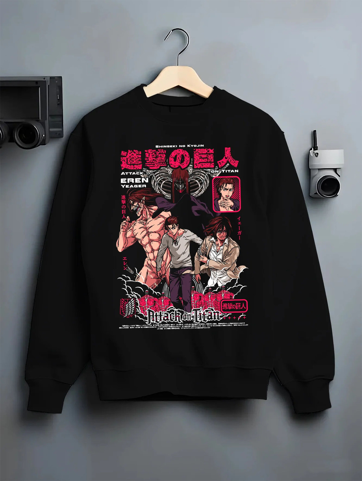 Black crewneck sweatshirt on hanger showing Attack on Titan: several Titans and Eren battle collage