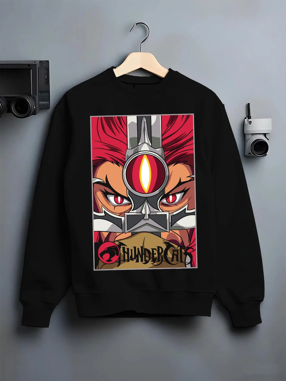 Black crewneck sweatshirt on hanger featuring Thundercats Eye of Thundera artwork.