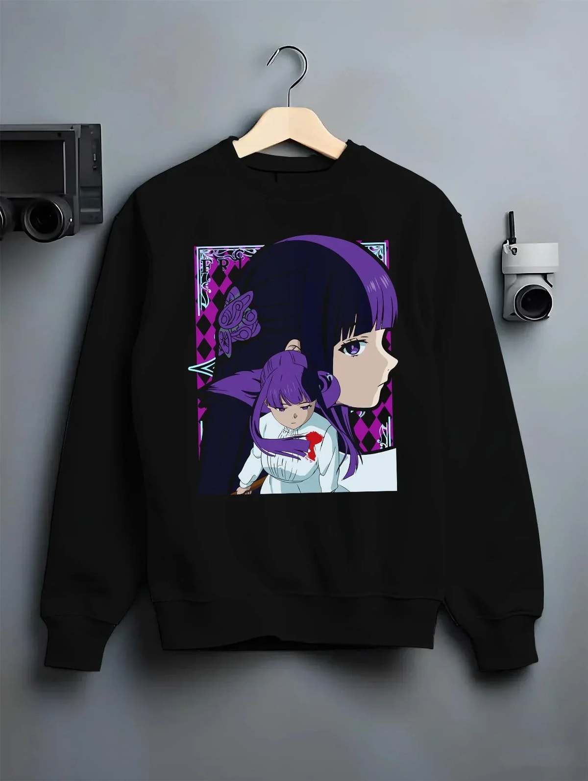 Black crewneck sweatshirt on hanger with Frieren Hoodie Beyond Journey’s End Purple Dress graphic bold anime graphic.