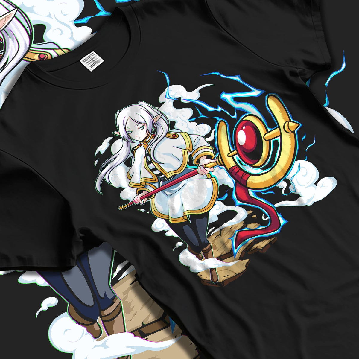 Black T-shirt laid flat with natural fabric folds, featuring Black Clover Mereoleona anime poster artwork with RPG fantasy glowing lightning sword detail.
