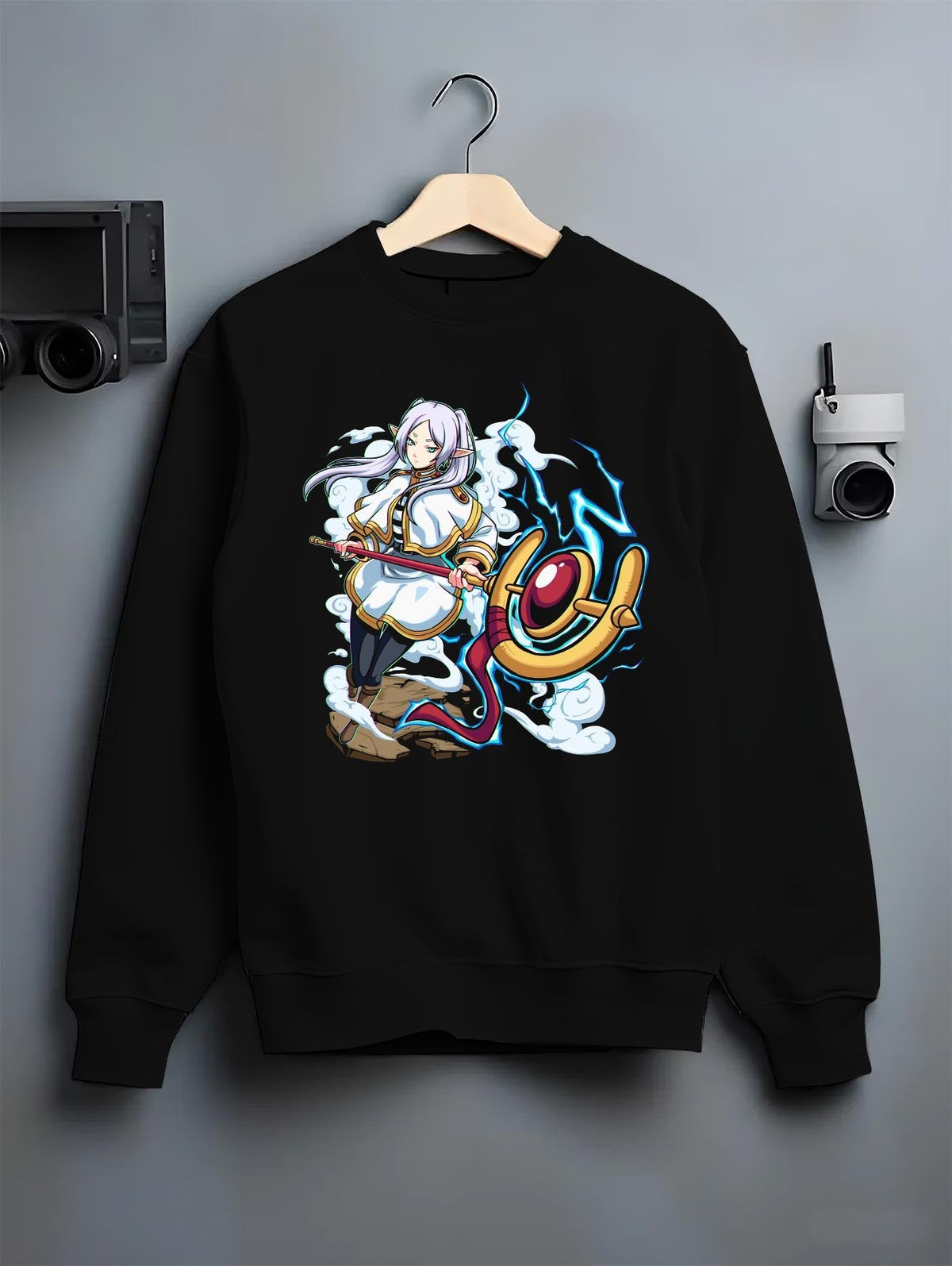 Black crewneck sweatshirt on a hanger against a grey wall, featuring Black Clover Mereoleona Japanese animation streetwear design with vibrant blue lightning effect.