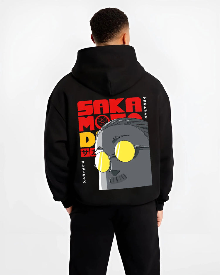 Black hoodie worn by male model from the back featuring Sakamoto Days gas mask assassin artwork.