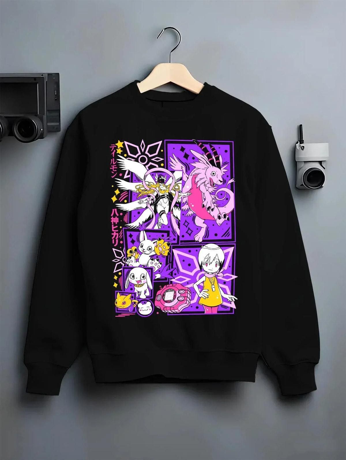 Black crewneck sweatshirt on hanger with Digimon Hoodie Gatomon Digital Monster Anime Jumper graphic premium wear.