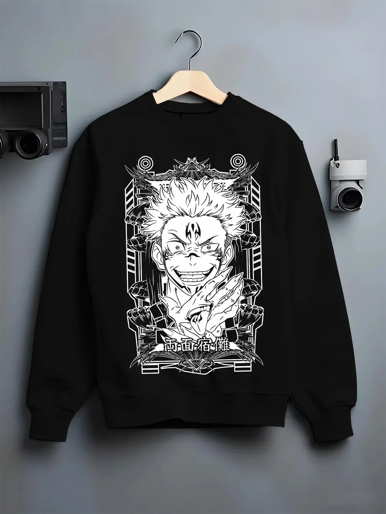 Black crewneck sweatshirt on hanger with Jujutsu Kaisen Hoodie Sukuna Grin Domain Jumper graphic bold anime graphic.