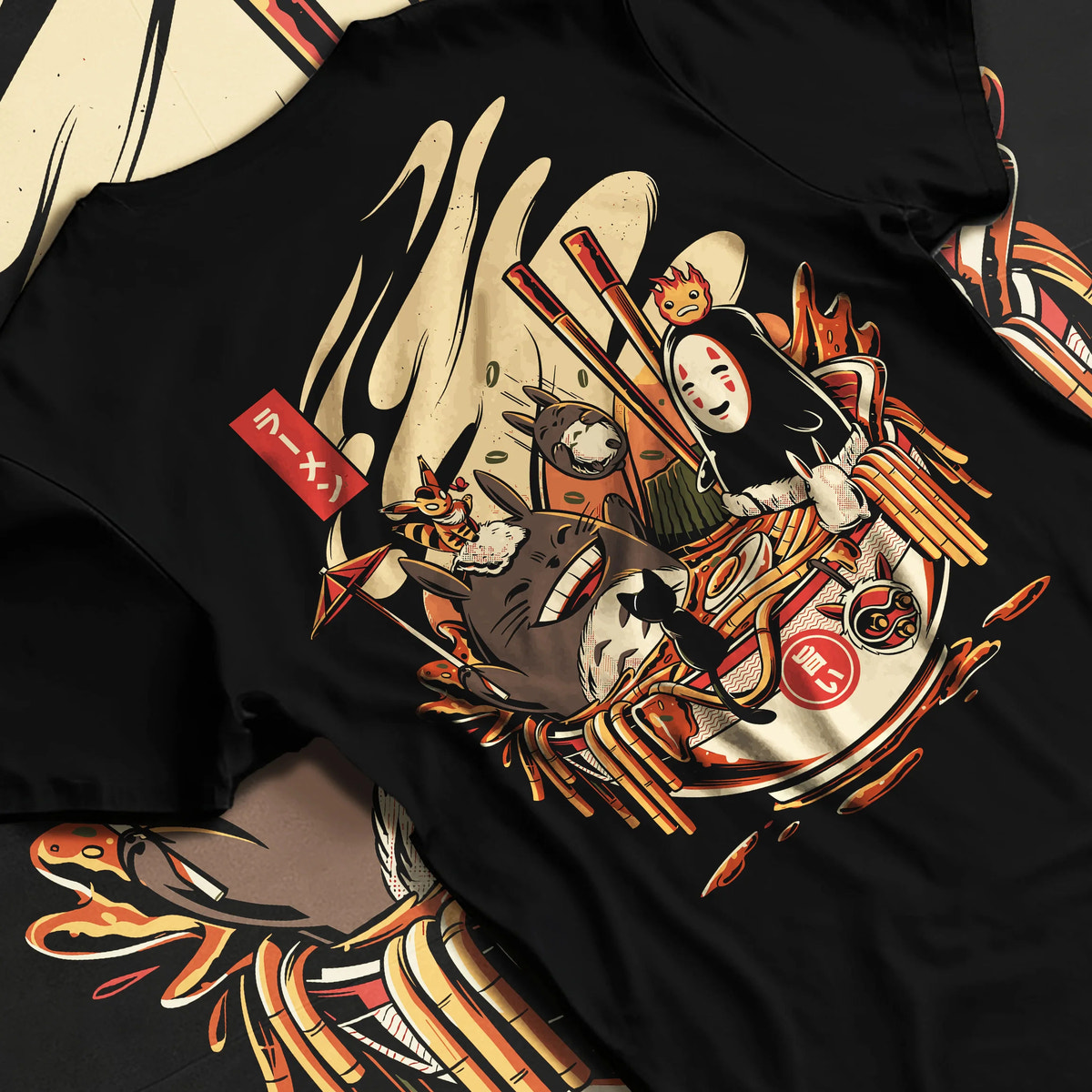 Black T-shirt flat back view showing Totoro, No-Face, Calcifer from Studio Ghibli: ramen crossover