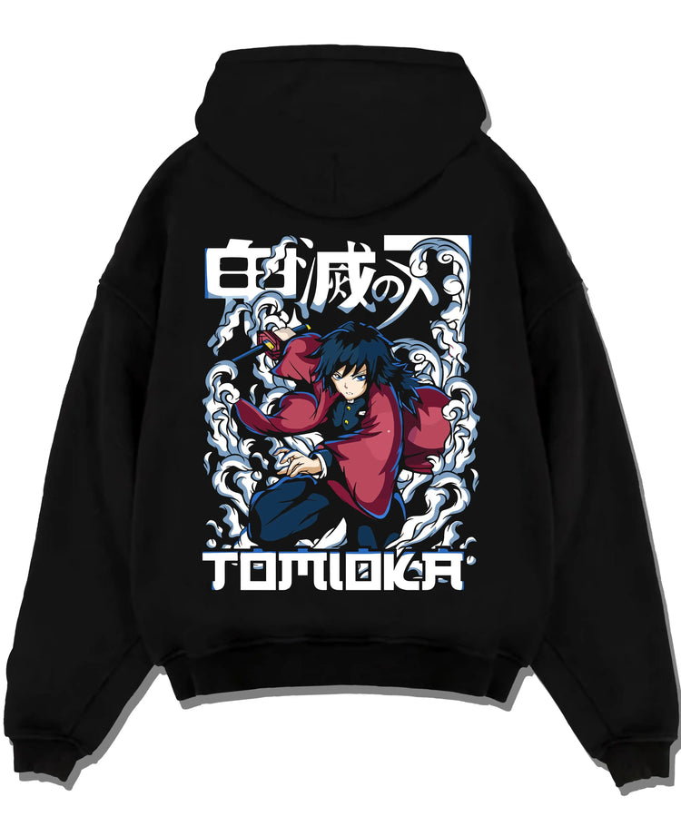 Black pullover hoodie laid flat with Demon Slayer Hoodie Giyu Tomioka Dynamic Pose Jumper graphic bold anime graphic.