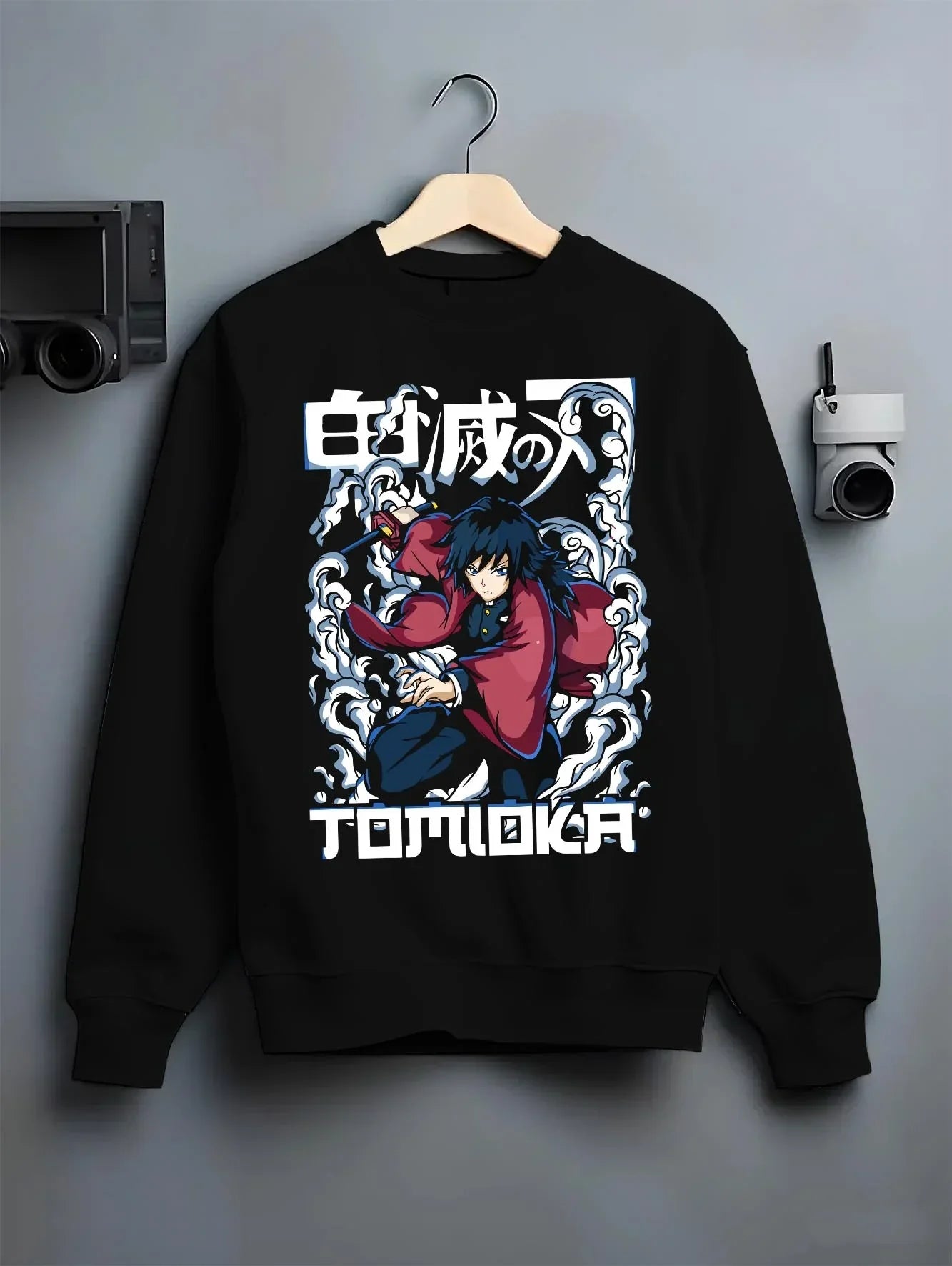 Black crewneck sweatshirt on hanger with Demon Slayer Hoodie Giyu Tomioka Dynamic Pose Jumper graphic streetwear graphic.