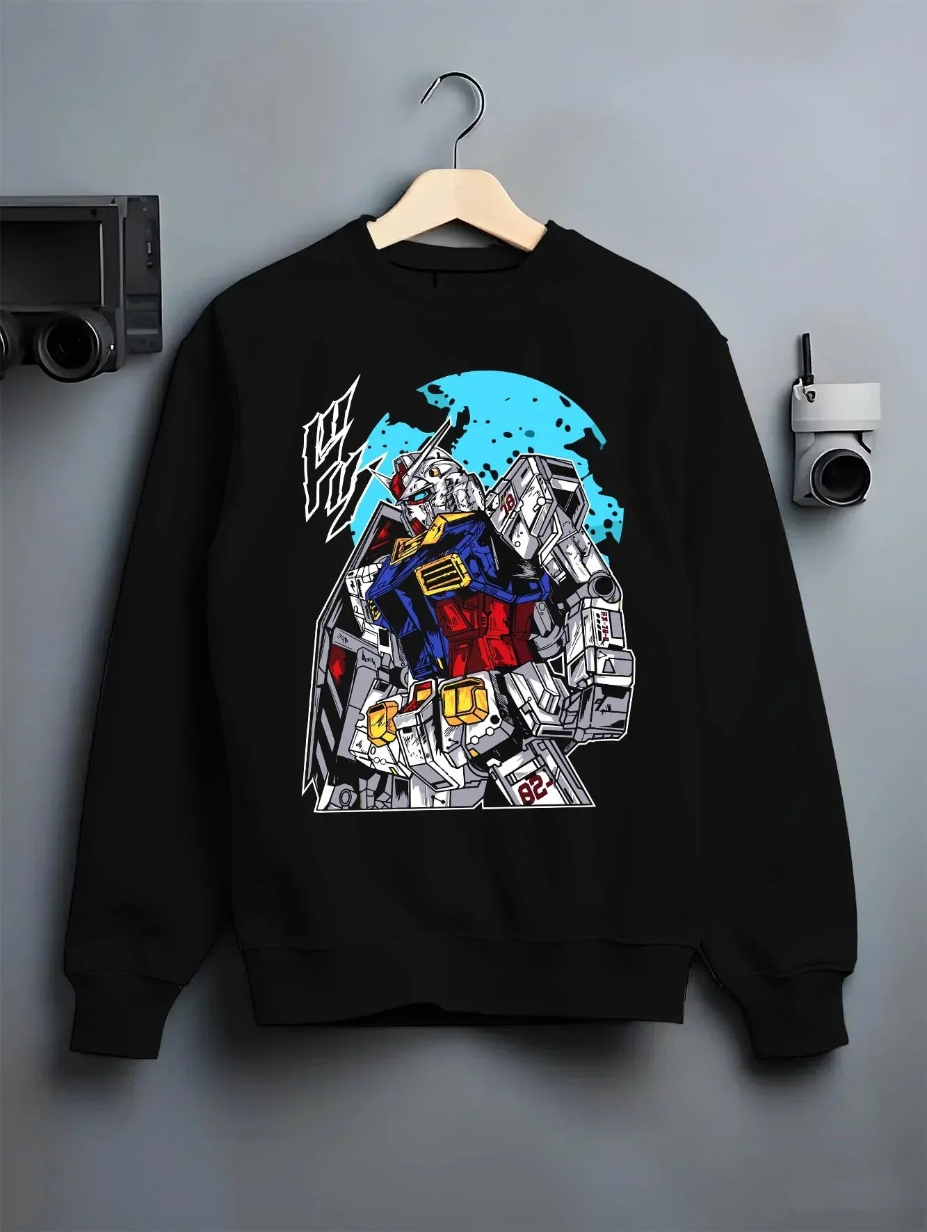 Black crewneck sweatshirt on hanger with Gundam Hoodie RX-78 Battle Suit Heroic Jumper graphic premium wear.