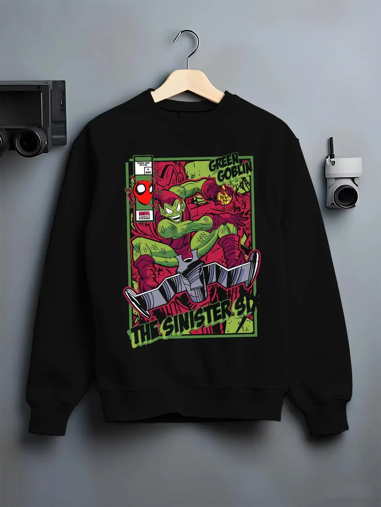 Black crewneck sweatshirt on hanger with Green Goblin Hoodie Marvel Sinister Spider Villain graphic bold anime graphic.