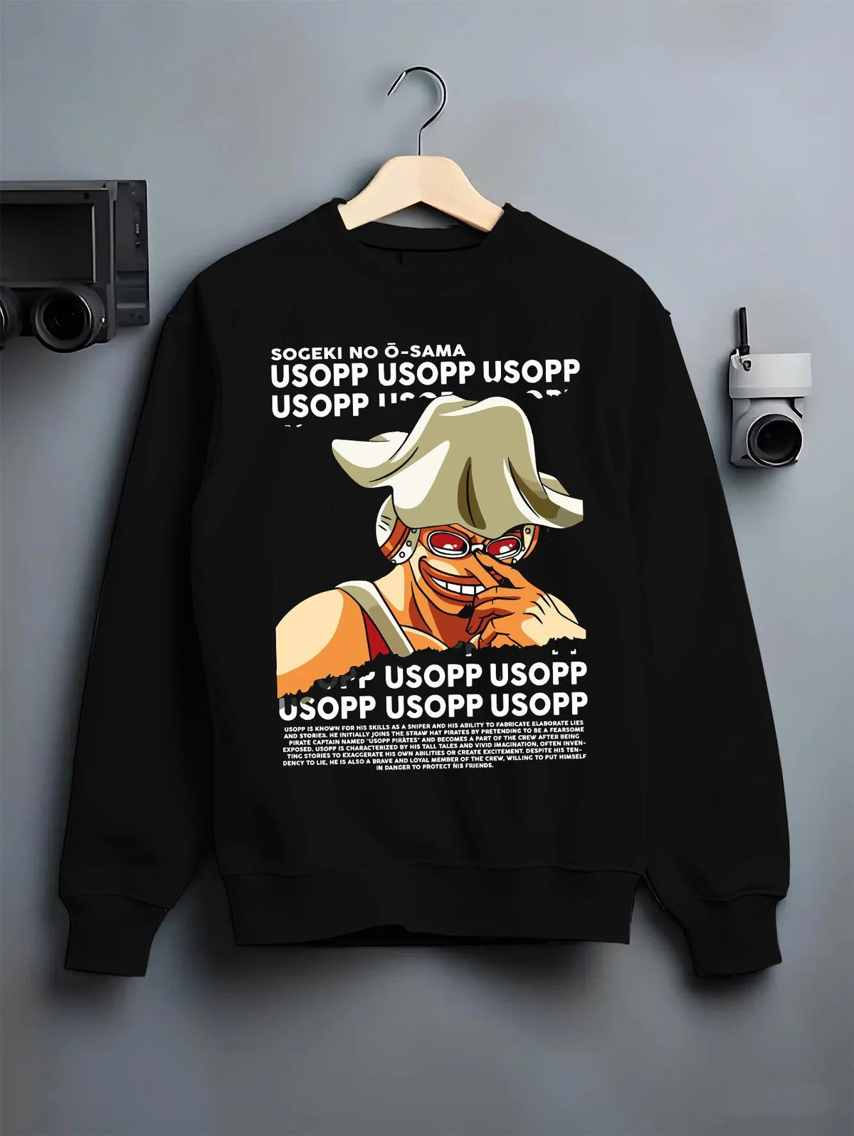 Black crewneck sweatshirt on hanger featuring God Usopp One Piece meme sniper artwork.