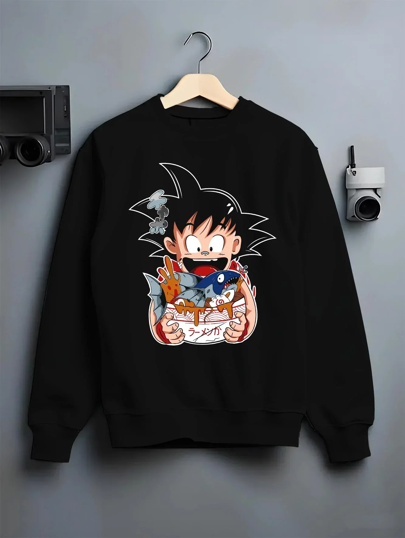 Black crewneck sweatshirt on hanger with Dragon Ball Z Hoodie Kid Goku Classic Jumper graphic premium wear.