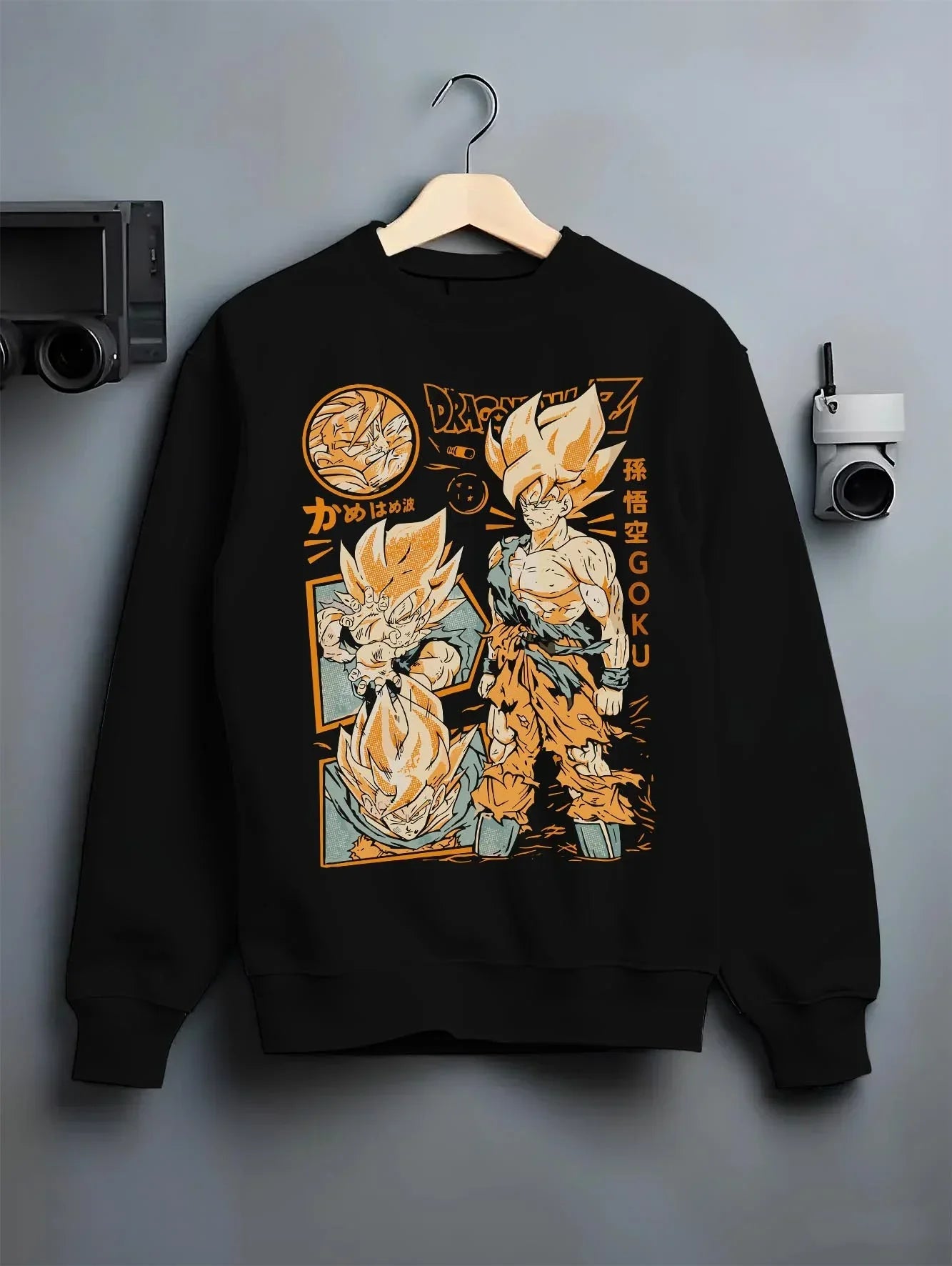 Black crewneck sweatshirt on hanger with Goku Hoodie Dragon Ball Z Super Saiyan Kamehameha graphic Goku themed artwork.