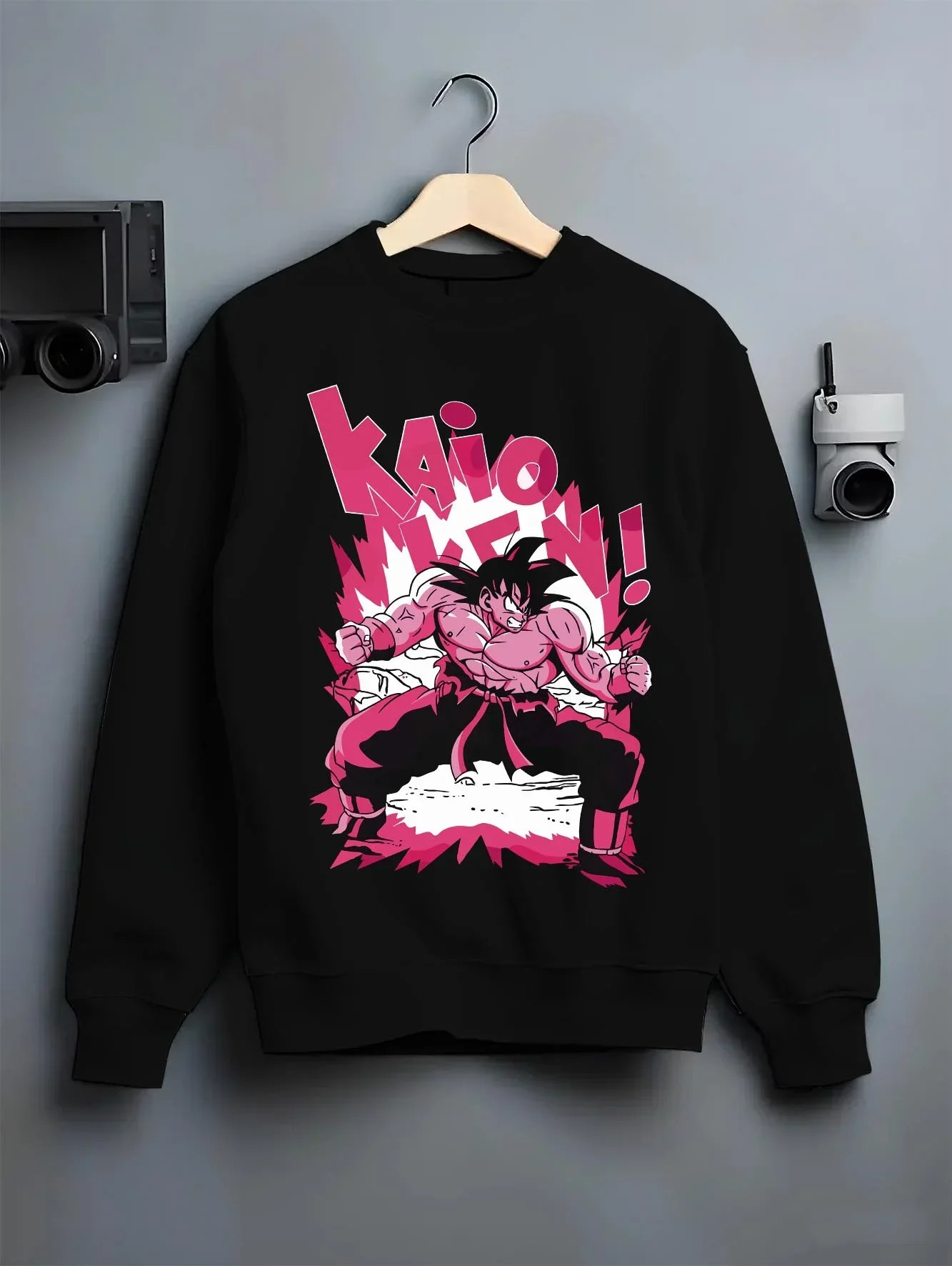 Black crewneck sweatshirt on hanger with Dragon Ball Z Hoodie Goku Kaio Ken Power Jumper graphic Goku themed artwork.