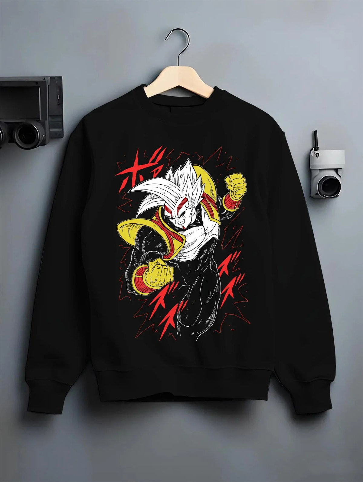 Black crewneck sweatshirt on hanger featuring golden Saiyan warrior artwork.