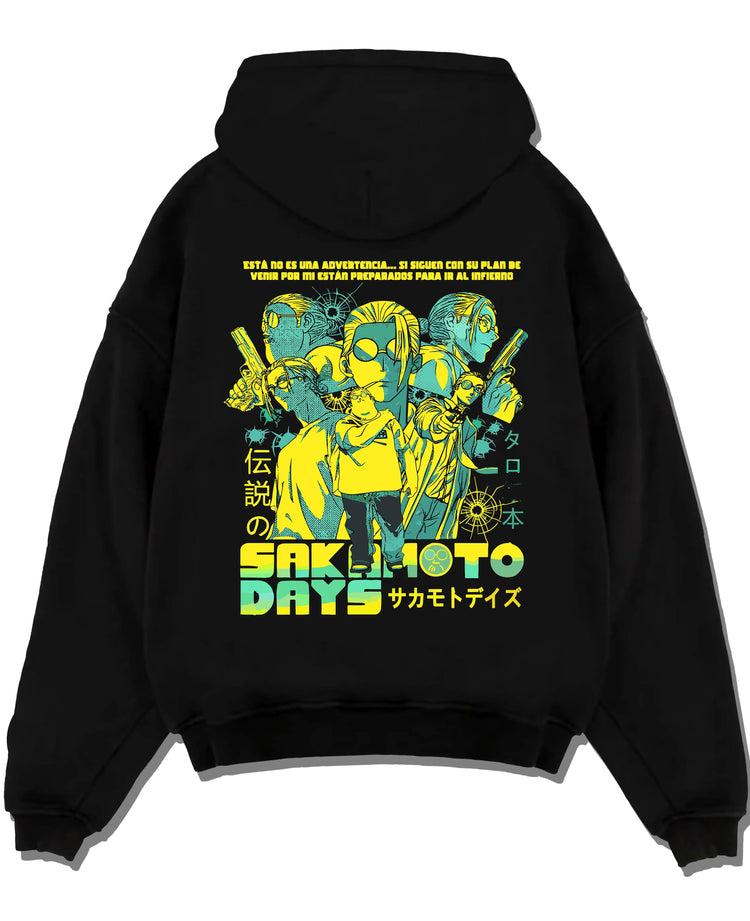 Black hoodie laid flat featuring Sakamoto Days trio action artwork.
