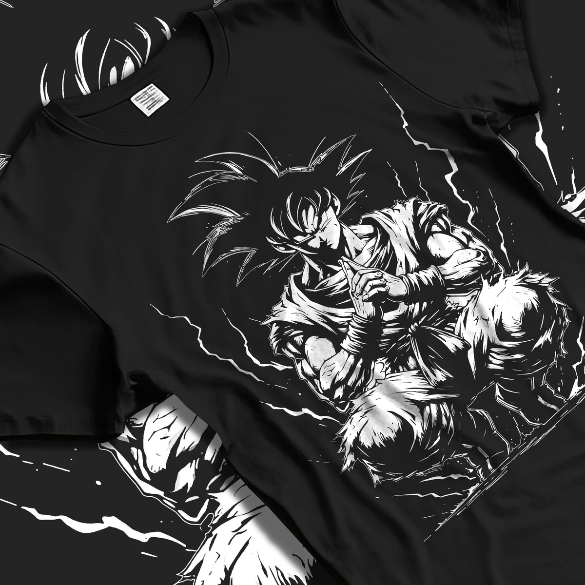 Black T-shirt laid flat with natural fabric folds, featuring Dragon Ball Goku anime poster inspired meditation pose artwork with lightning aura in dark manga panel style.