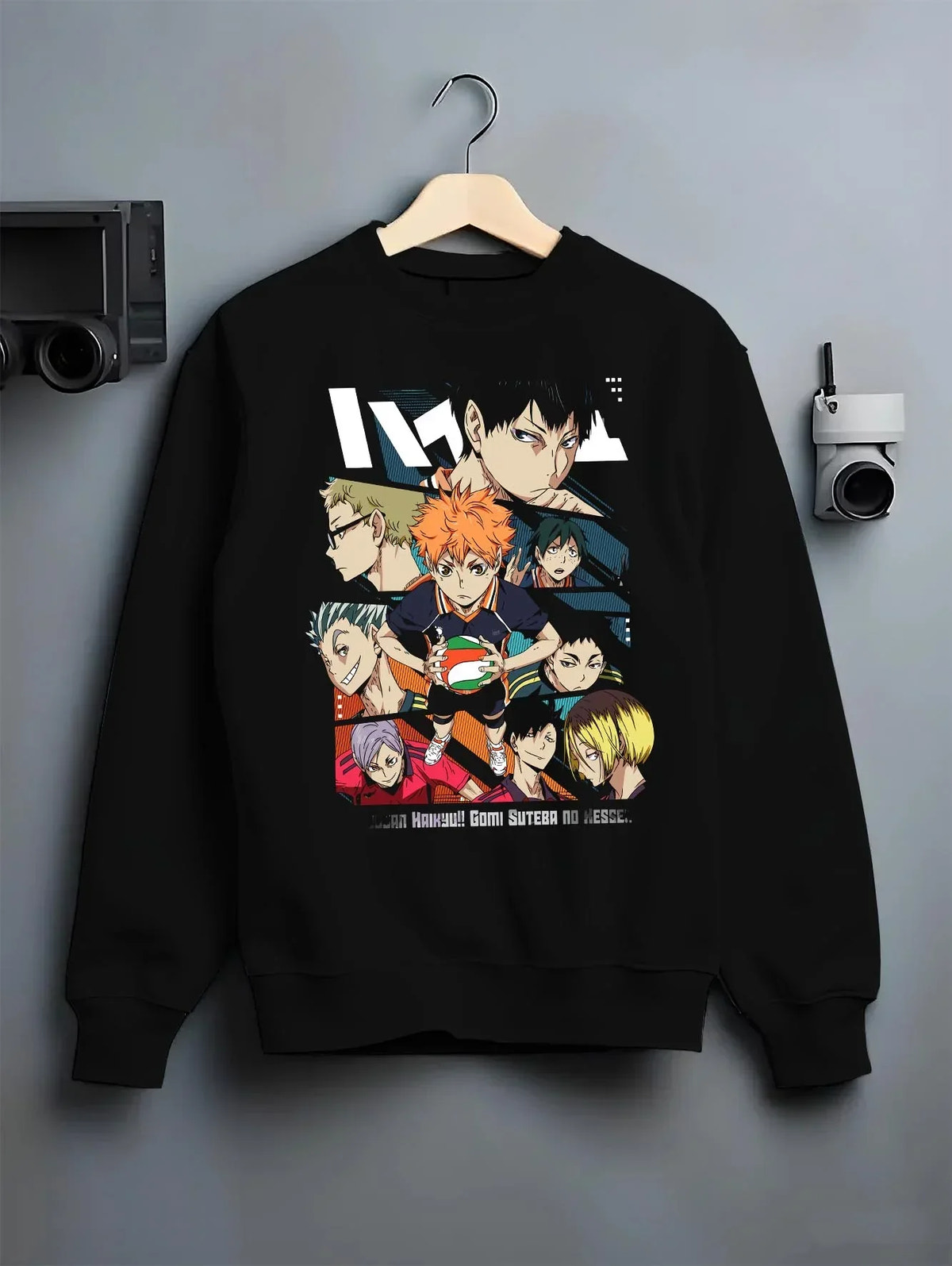 Black crewneck sweatshirt on hanger with Haikyuu Hoodie Shoyo Hinata Team Spirit Jumper graphic streetwear graphic.