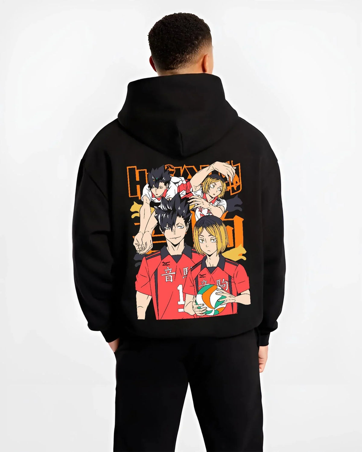 Black hoodie worn by male model, back view with Haikyuu Hoodie Nekoma vs Karasuno Rival Jumper graphic nan anime design.