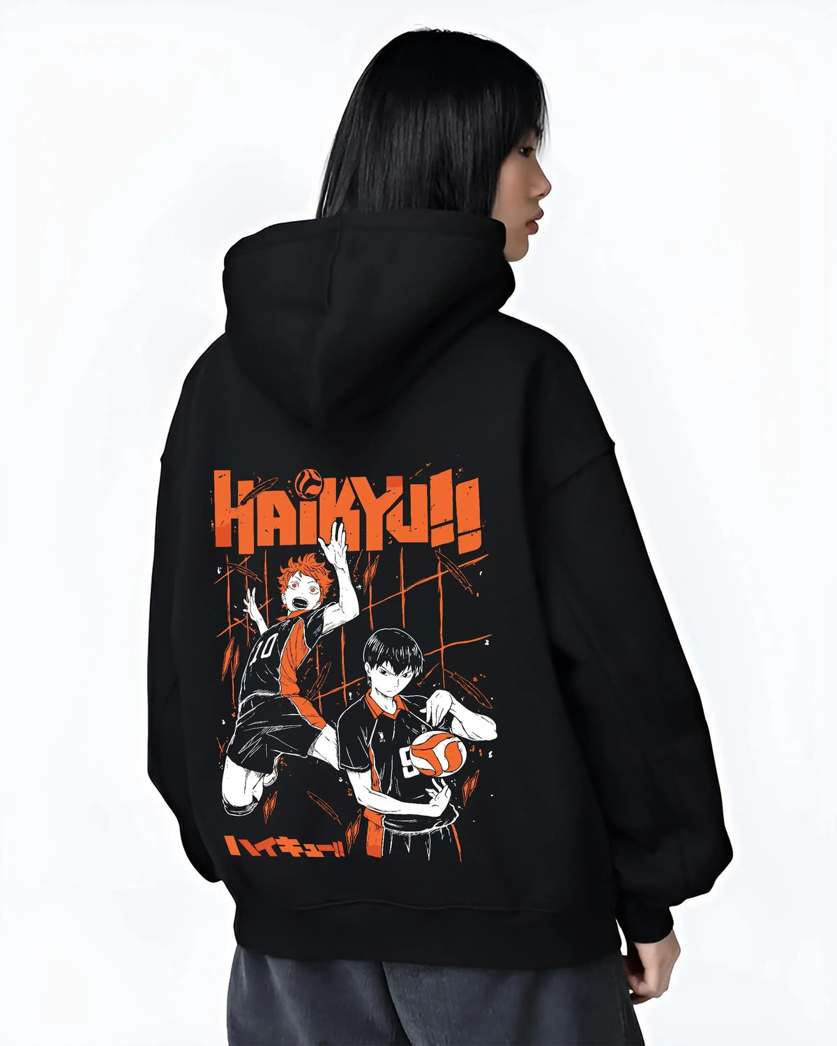 Black hoodie worn by female model, back view with Haikyuu Hoodie Shoyo Hinata Tobio Kageyama Jumper graphic bold anime graphic.