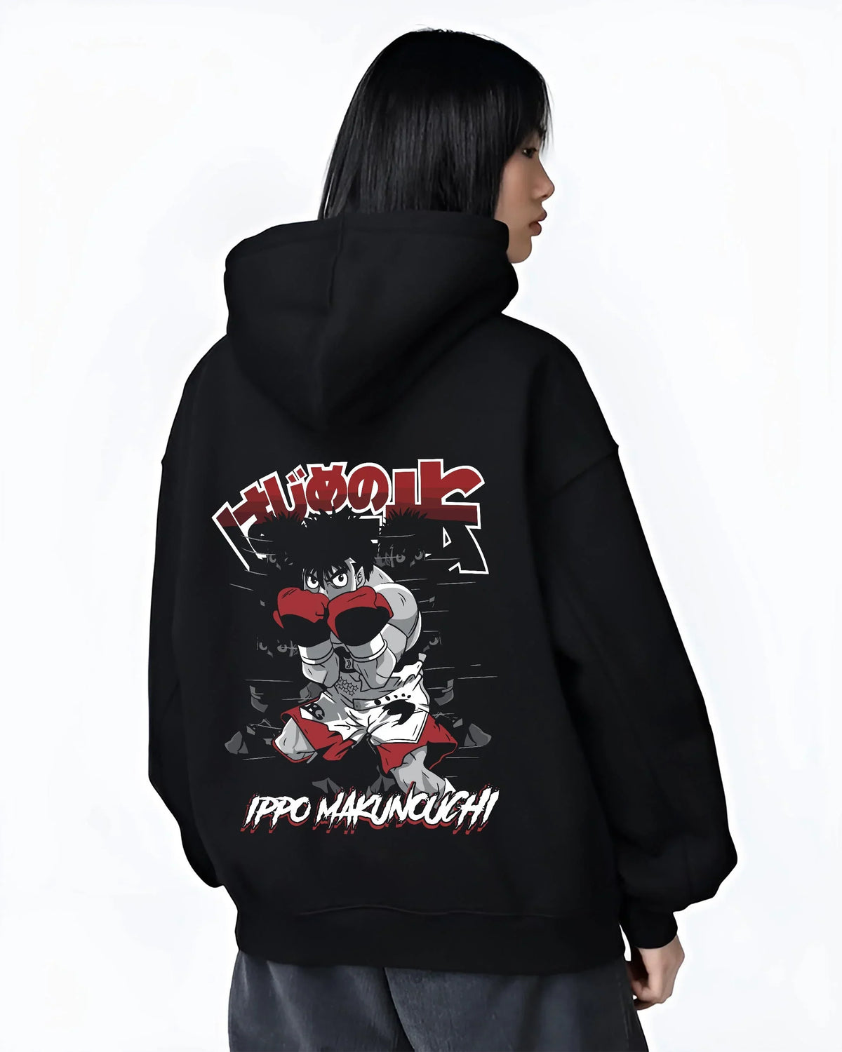 Black hoodie worn by female model, back view with Hajime no Ippo Hoodie Ippo Makunouchi Determined graphic premium wear.
