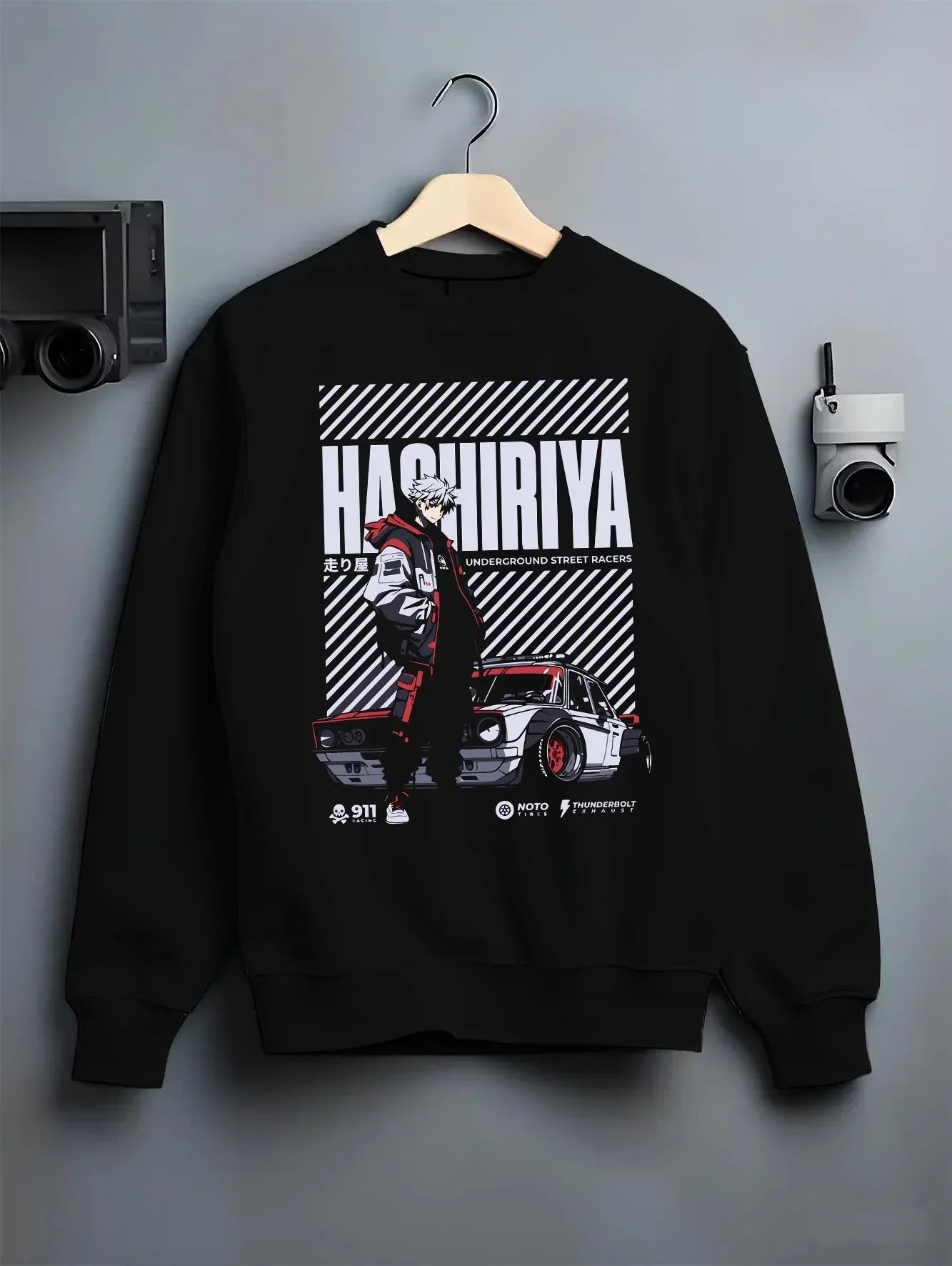 Black crewneck sweatshirt on a hanger against a grey wall, feBlack crewneck sweatshirt on a hangBlack crewneck sweatshirt on a hanger against a grey wall, featuring ACURA NSX turbo race street racing performance graphic.Black crewneck sweatshirt on a hanger against a grey wall, featuring Dodge Charger muscle retro racing street performance graphic.er against a grey wall, featuring Volkswagen Beetle racing classic legend street graphic.aturing rs race drift jdm tokyo street underground racing graphic.
