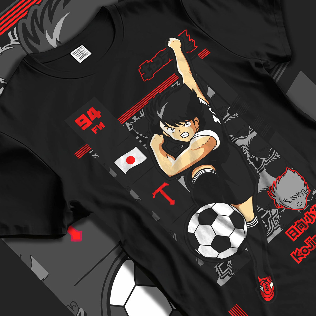 Black T-shirt laid flat with natural folds featuring Kojiro Hyuga Tiger Shot football artwork.