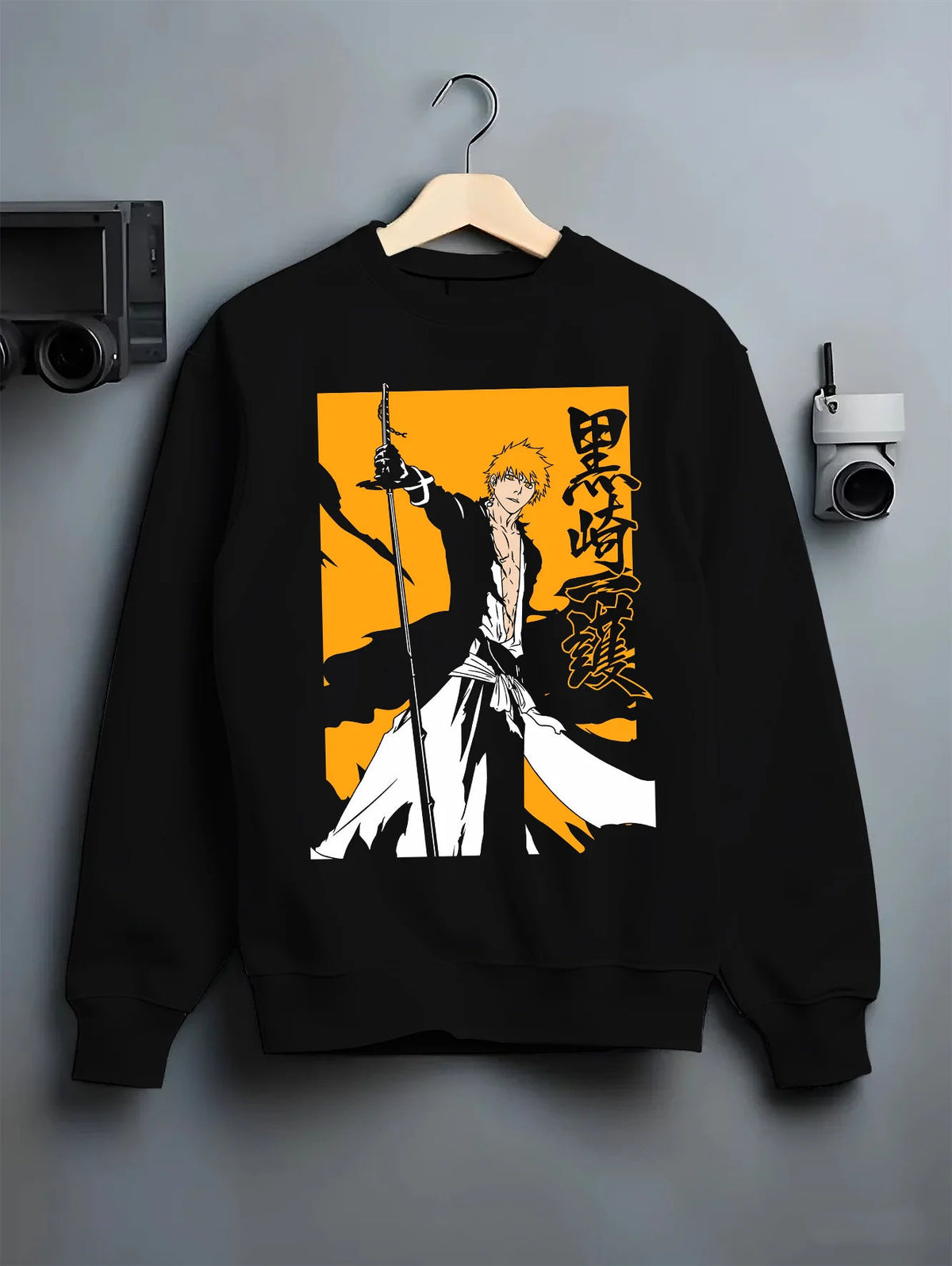 Black crewneck sweatshirt on hanger showing Ichigo Kurosaki from Bleach: sword silhouette on yellow