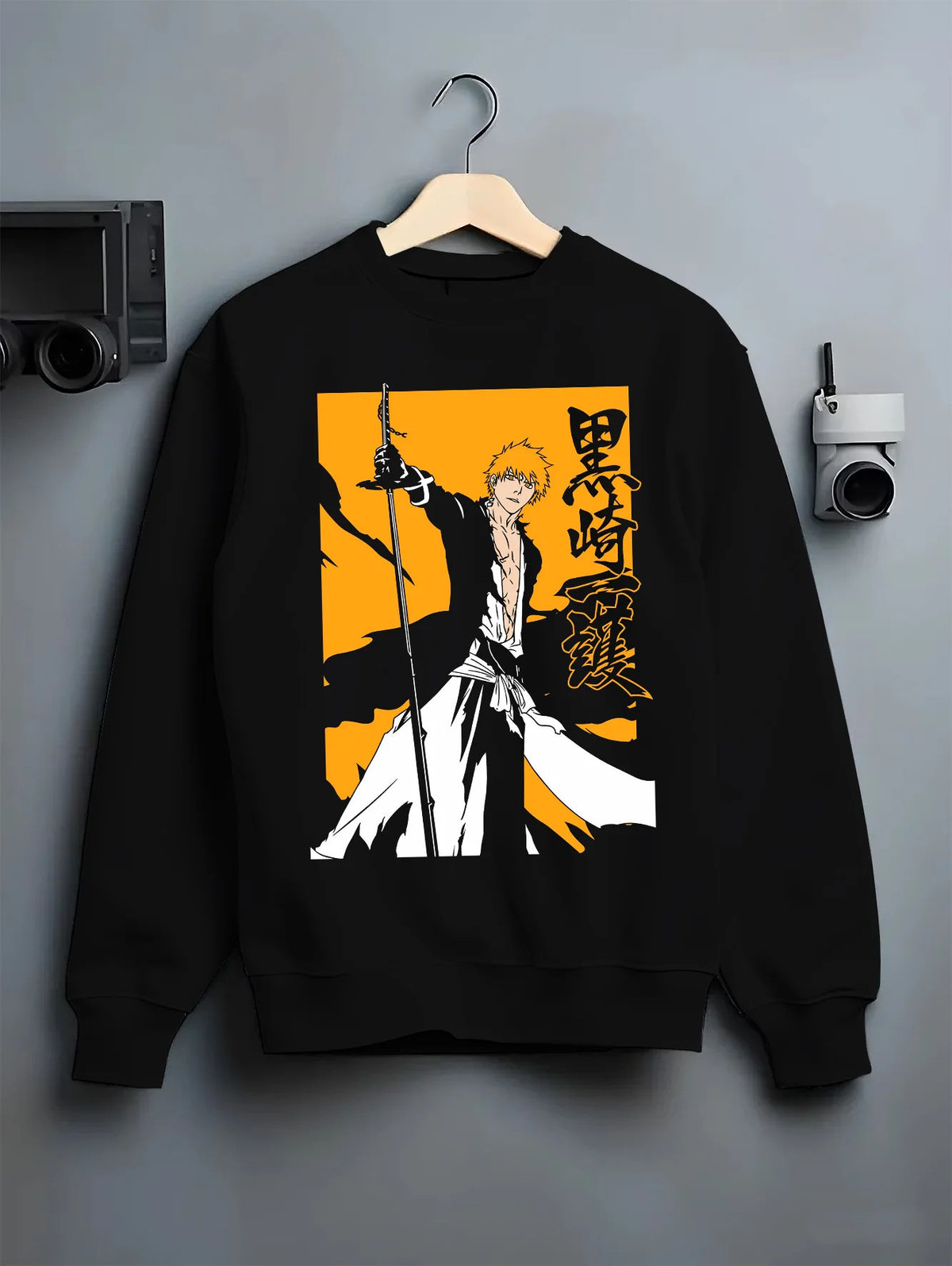 Black crewneck sweatshirt on hanger showing Ichigo Kurosaki from Bleach: sword silhouette on yellow