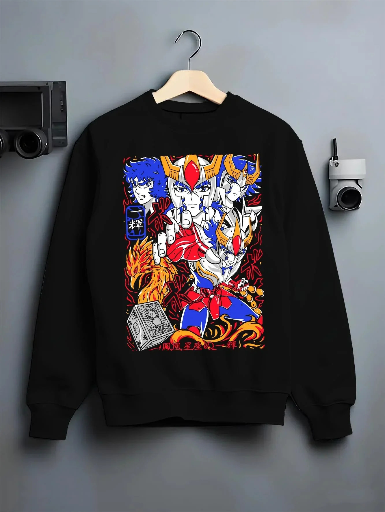 Black crewneck sweatshirt on hanger with Saint Seiya Hoodie Ikki Phoenix Bronze Saint Jumper graphic bold anime graphic.