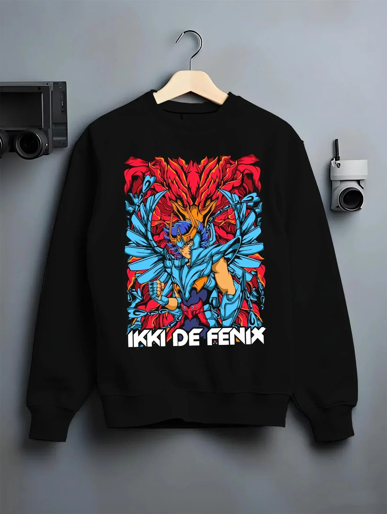 Black crewneck sweatshirt on hanger with Saint Seiya Hoodie Ikki Phoenix Rising Flames Jumper graphic Ikki anime design.
