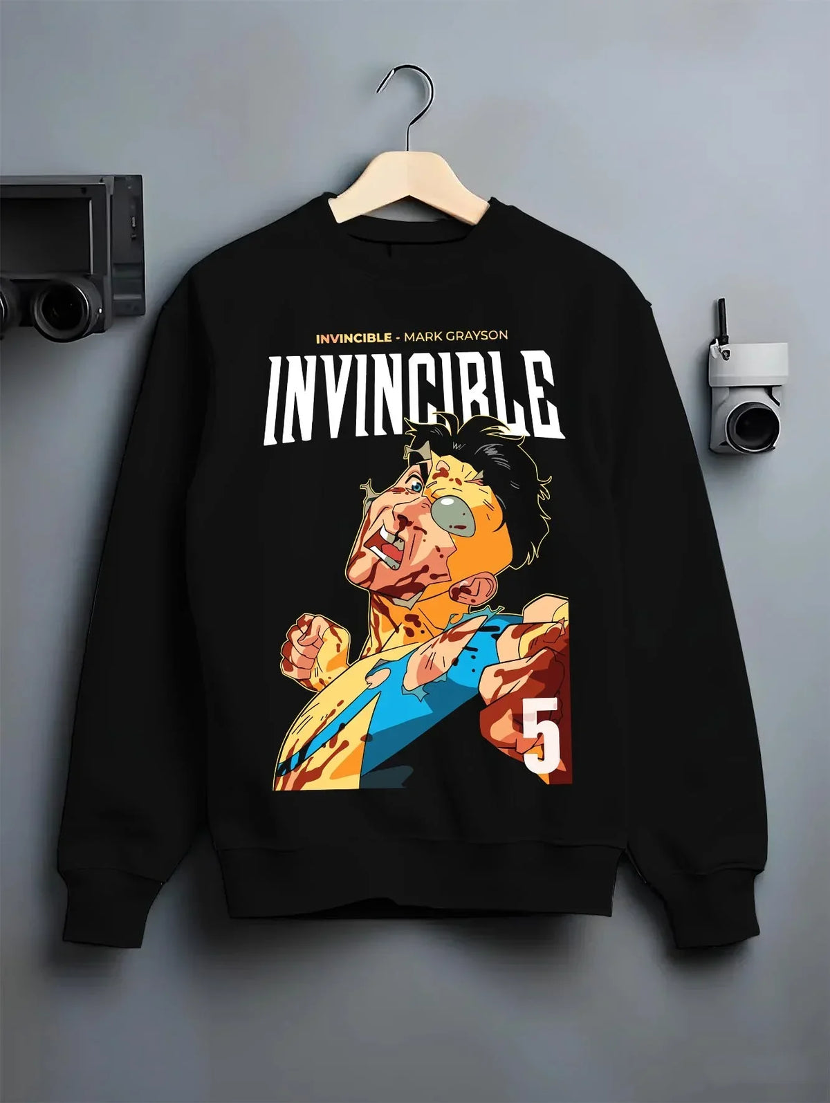 Black crewneck sweatshirt on hanger with Invincible Hoodie Mark Grayson Battle Damage Jumper graphic bold anime graphic.