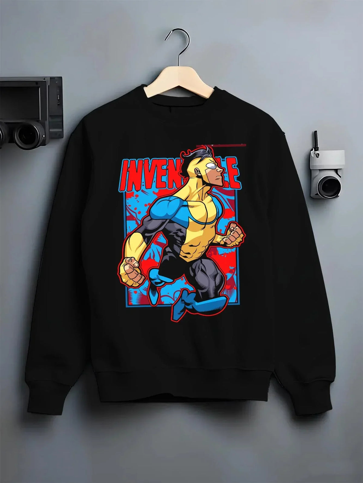 Black crewneck sweatshirt on hanger with Invincible Hoodie Mark Grayson Flying Hero Jumper graphic premium wear.