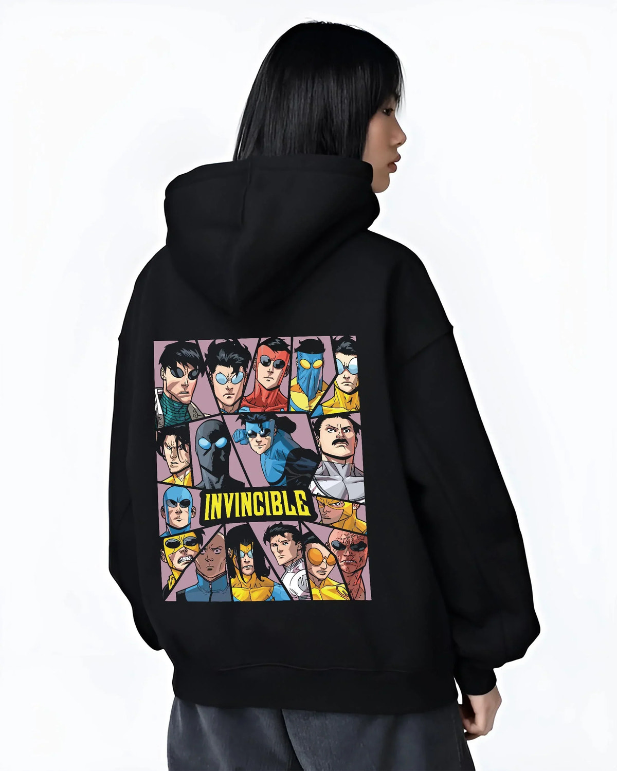 Black hoodie worn by female model, back view with Invincible Hoodie Mark Grayson Team Logo Jumper graphic bold anime graphic.