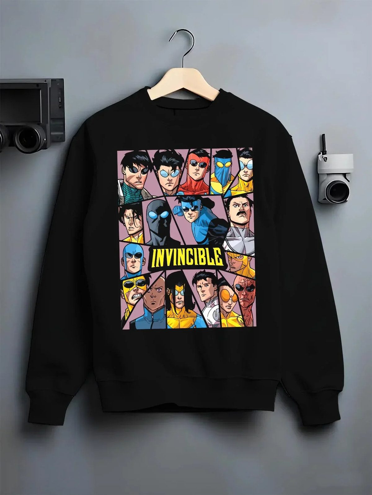 Black crewneck sweatshirt on hanger with Invincible Hoodie Mark Grayson Team Logo Jumper graphic bold anime graphic.