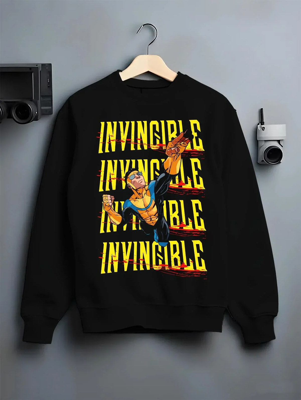 Black crewneck sweatshirt on hanger with Invincible Hoodie Mark Grayson Ultimate Strength Jumper graphic premium wear.